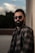 man in black sunglasses and gray and black plaid button up shirt