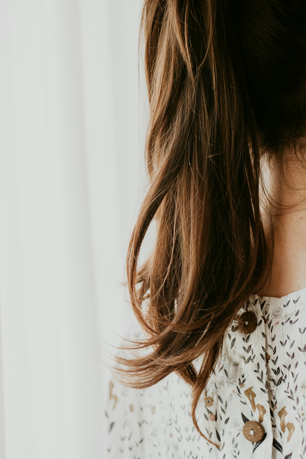 woman in white and black floral shirt