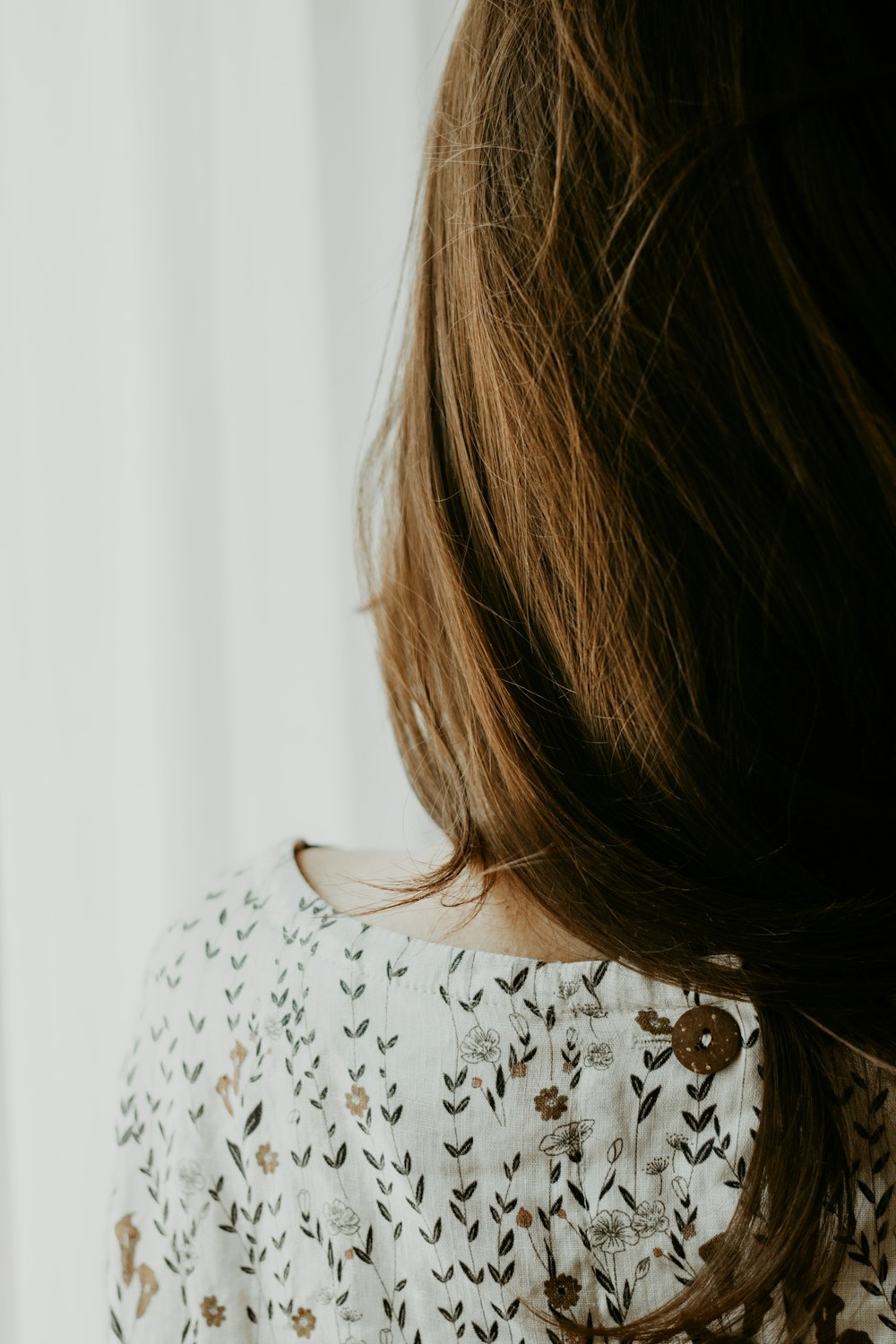 woman in white and black floral shirt