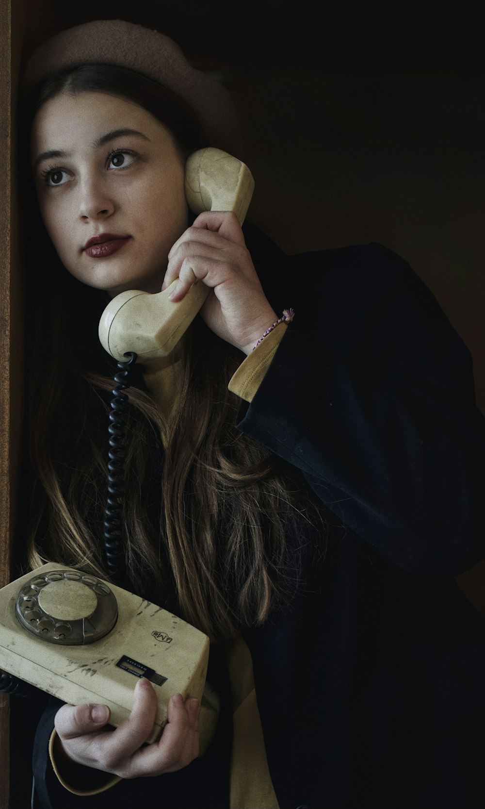 woman in black long sleeve shirt holding telephone