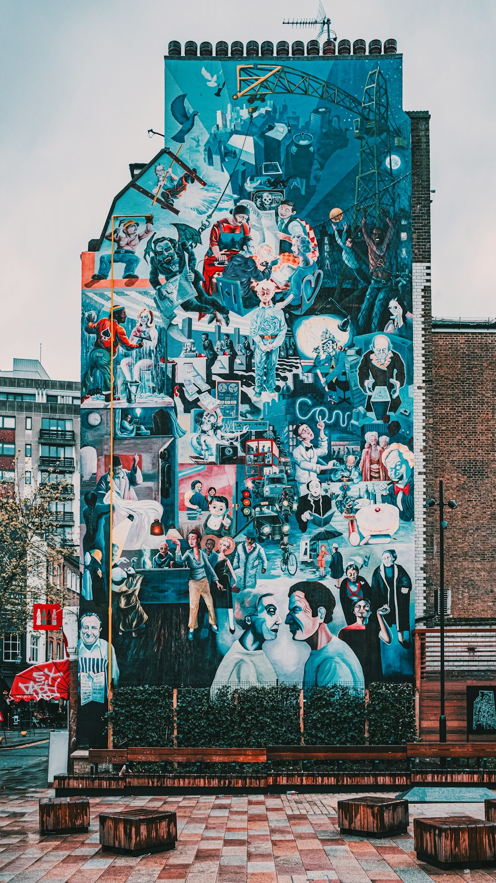 people standing near wall with graffiti during daytime