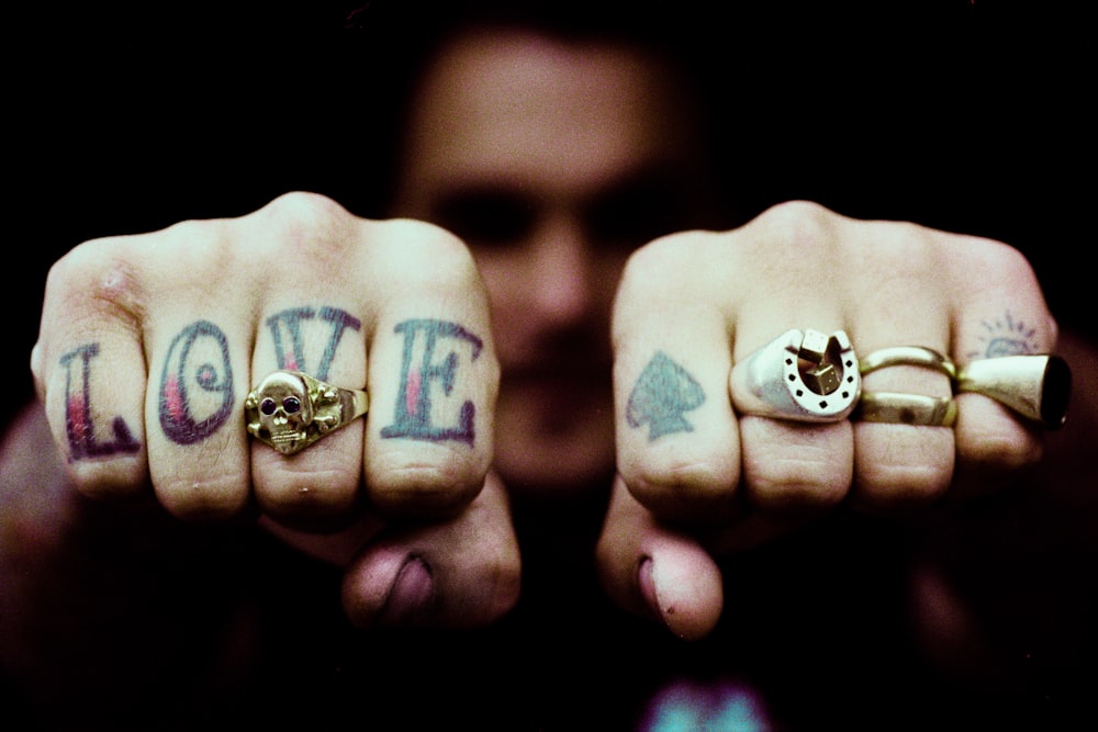 persons hand with silver ring