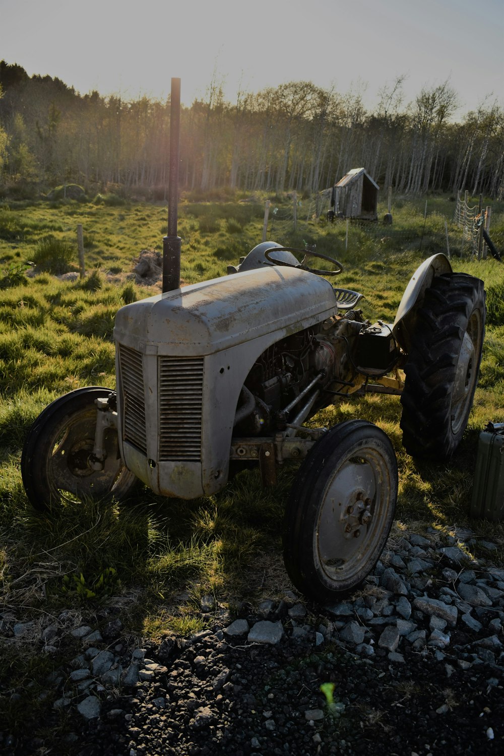 grayscale photo of tractor on green grass field