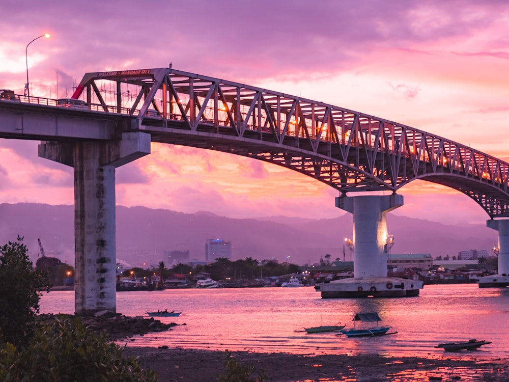 white concrete bridge over river under cloudy sky during daytime