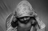 Close-up of a baby wrapped gently in a cozy bath towel after a soothing bath.