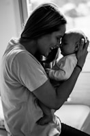 grayscale photo of man kissing womans cheek