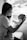 grayscale photo of woman in t-shirt carrying baby