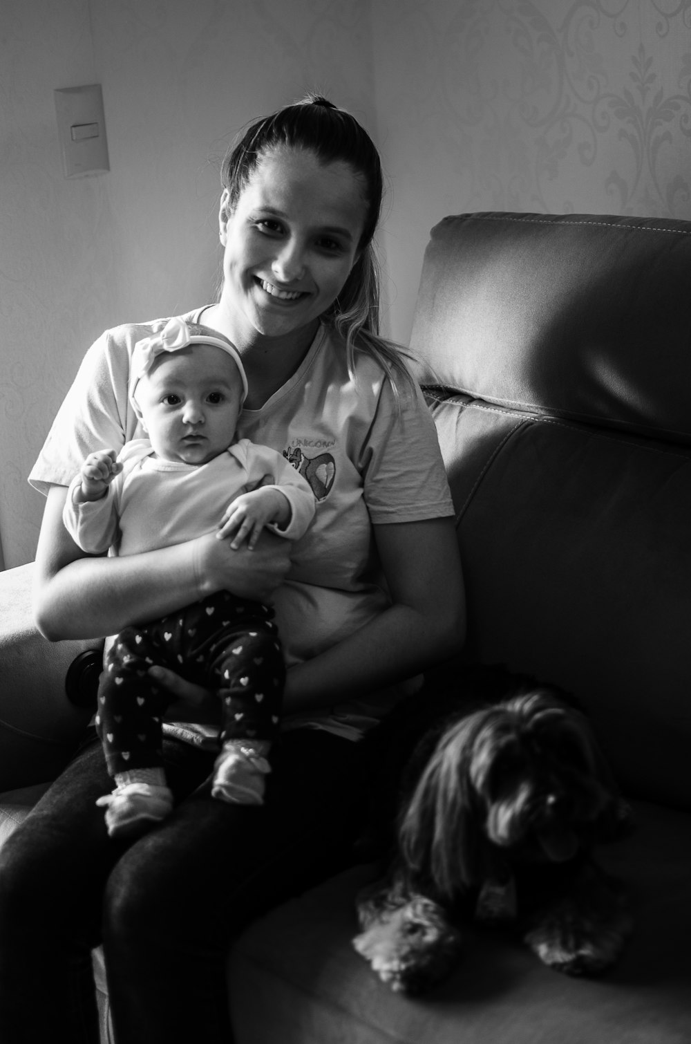 grayscale photo of woman carrying baby