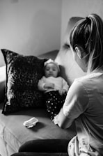 woman in long sleeve shirt carrying baby in grayscale photography