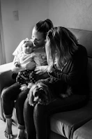 A warm, candid family moment caught in the backyard with pets lounging nearby.