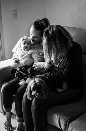 A warm, candid family moment caught in the backyard with pets lounging nearby.