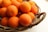A vibrant display of oranges in a rustic basket.