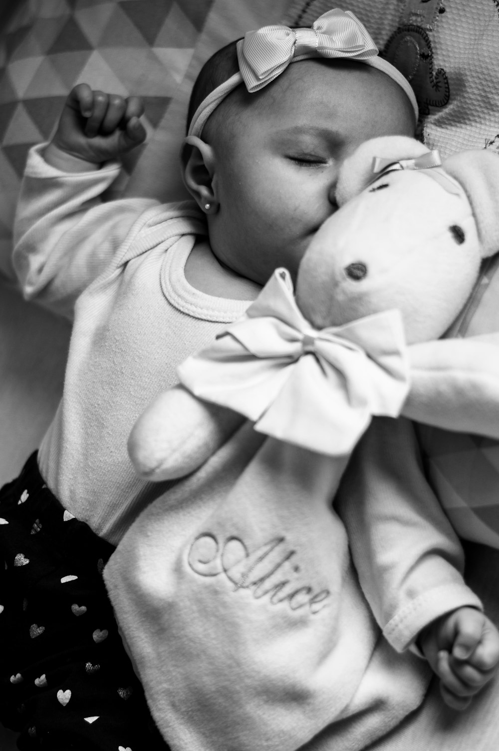 grayscale photo of baby in onesie