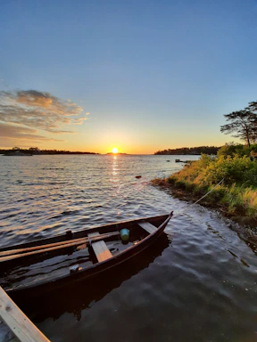 A serene sunset over the mangroves in the Gulf of Nicoya with a small boat ready for a tour.