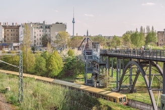gray metal bridge near white concrete building during daytime
