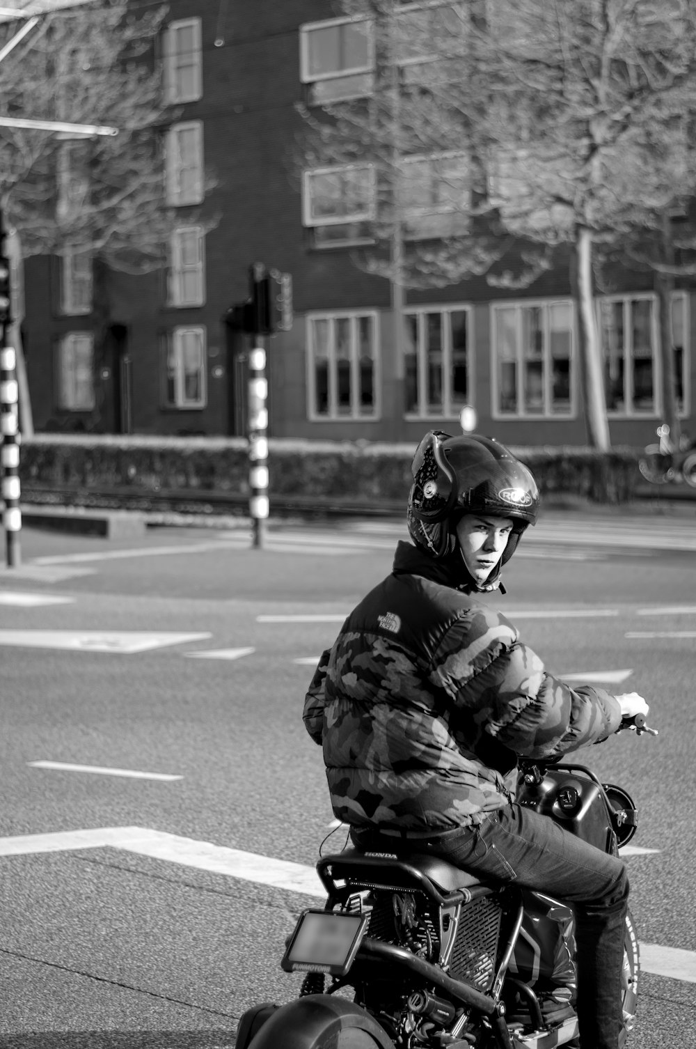 grayscale photo of man riding motorcycle