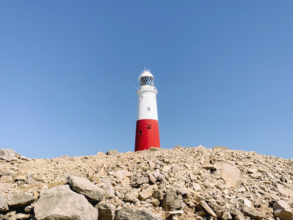 red and white lighthouse under blue sky during daytime