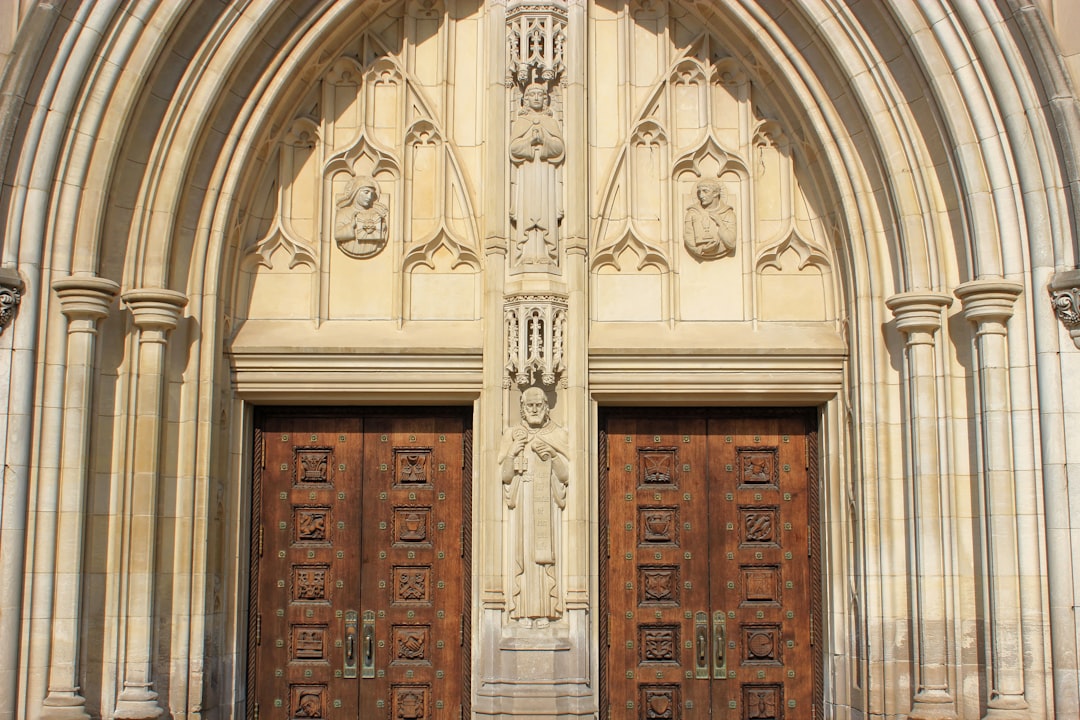 brown wooden door with cross