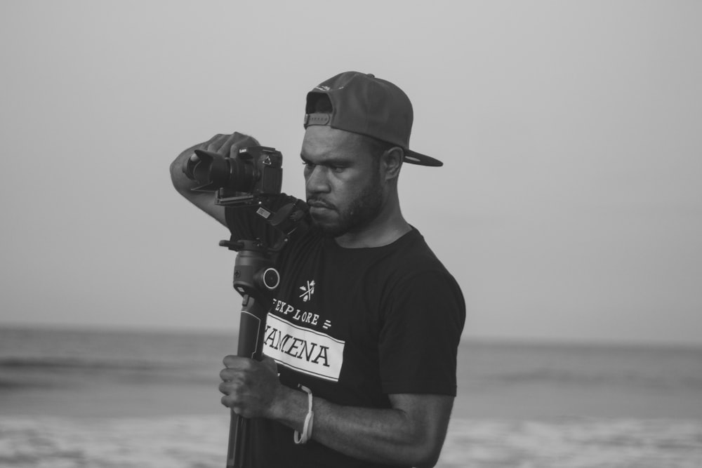 man in black crew neck t-shirt holding black microphone