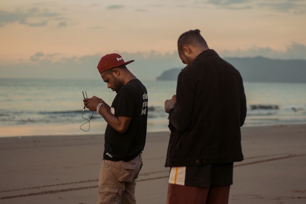 man in black shirt and brown shorts standing beside man in black shirt and brown shorts