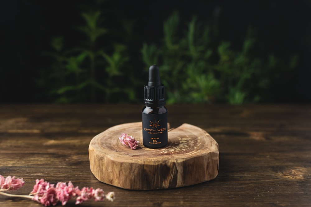 black and white spray bottle on brown wooden round table