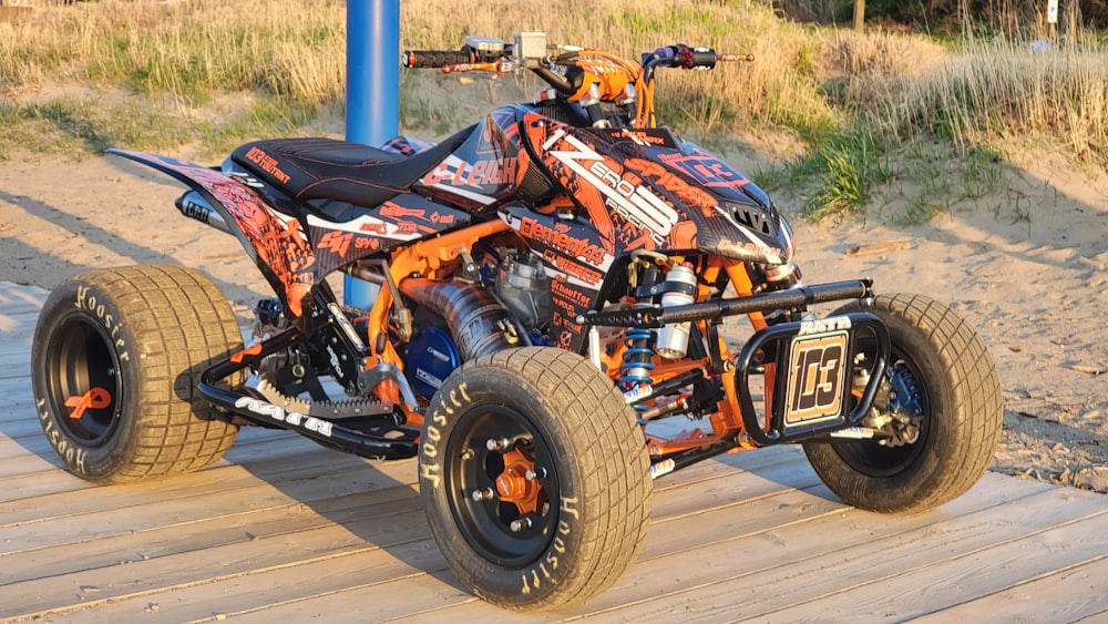 orange and black atv on gray wooden floor