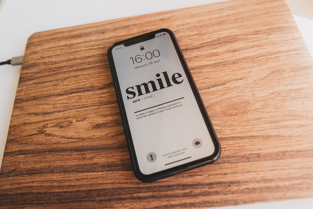 a cell phone sitting on top of a wooden table