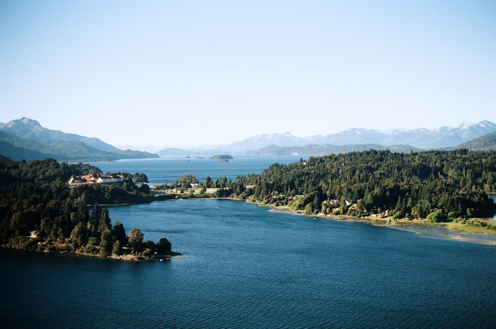 body of water near mountain during daytime