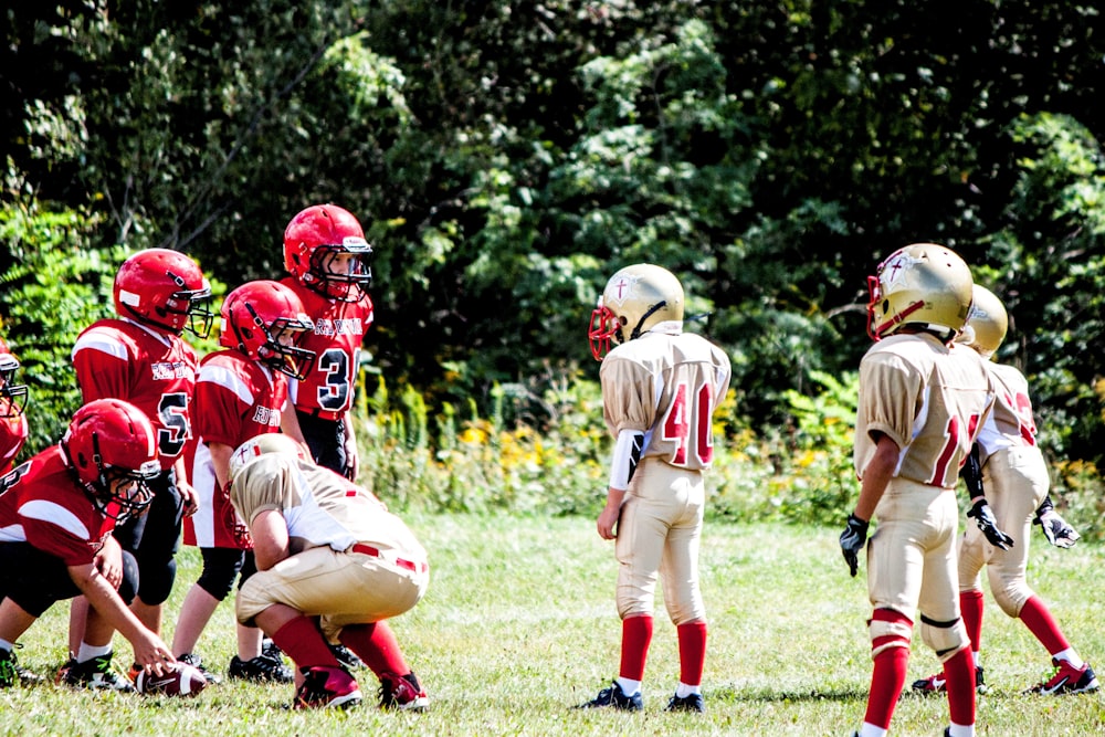 football players on green grass field during daytime