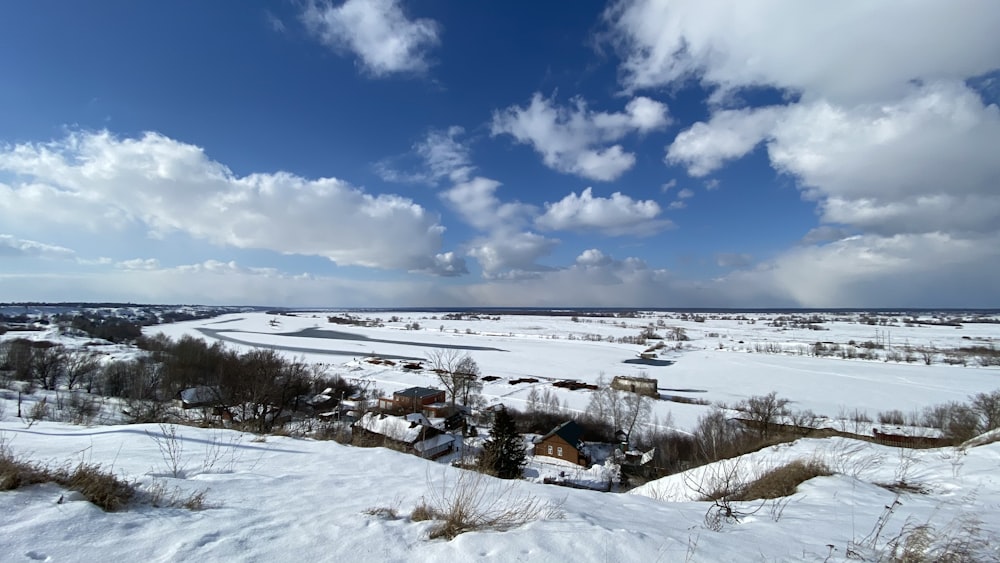 snow covered field under blue sky during daytime