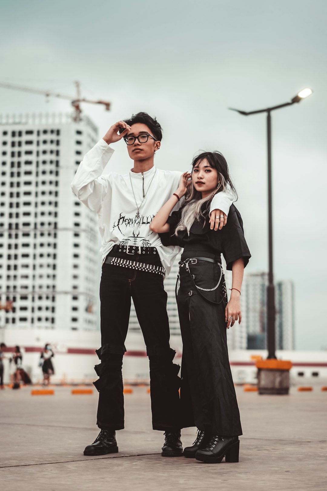 man in white dress shirt and black pants standing beside woman in black and white long