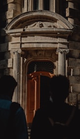 people standing in front of brown wooden door