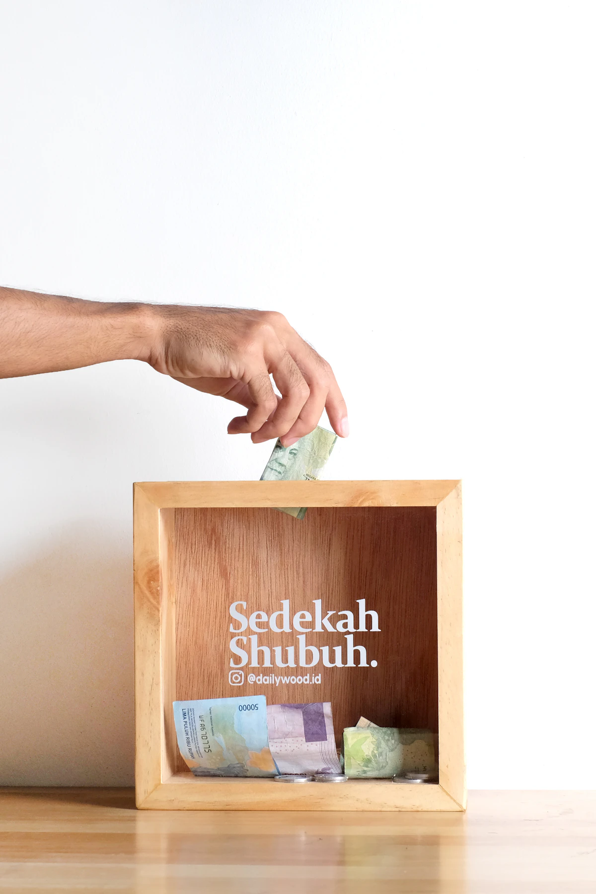 A wooden charity donation box, ready to be filled