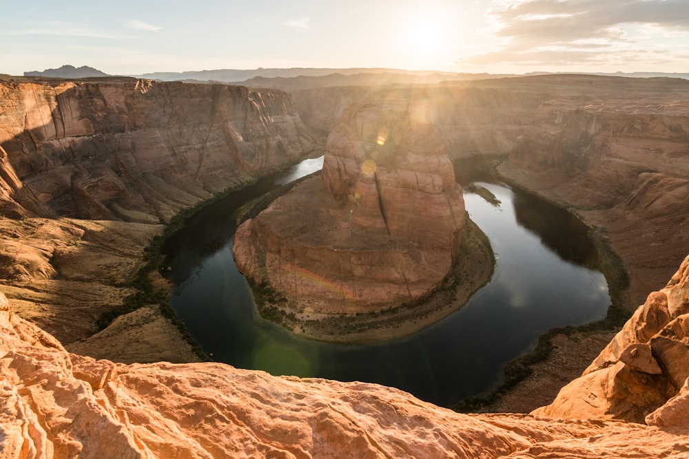 brown rock formation near body of water during daytime