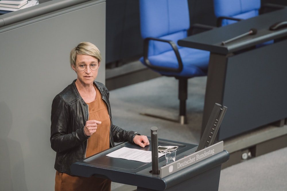 woman in black leather jacket sitting on chair