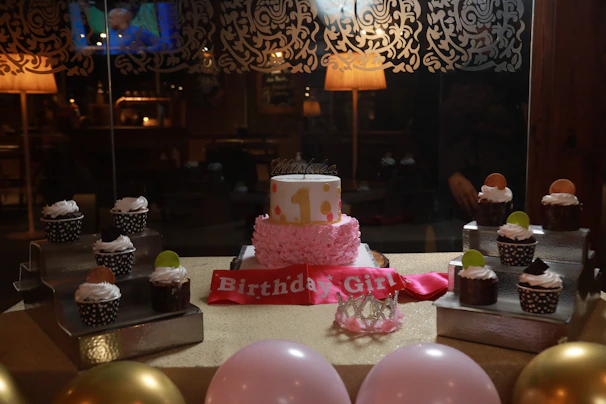 A festive birthday table set with bug-shaped cupcakes and themed party favors.