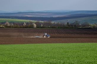 John Deere tractor working the fertile fields of southern Chile at sunrise.