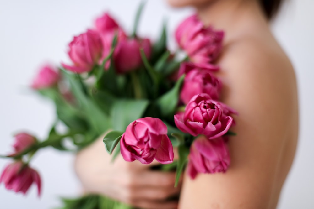 pink roses on persons lap