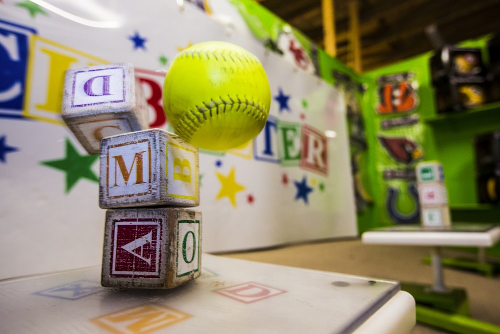 yellow and red baseball on white table