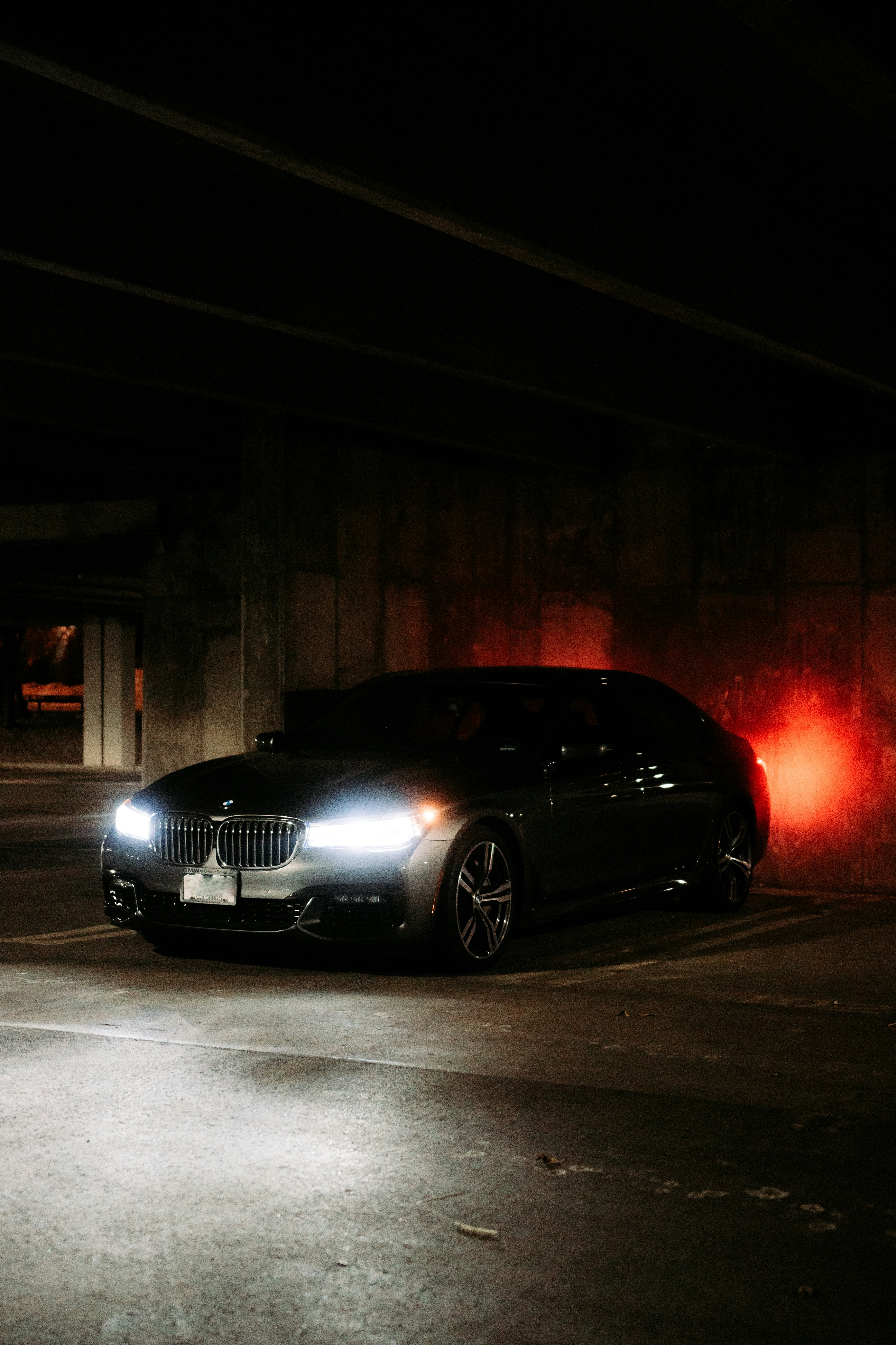 black bmw m 3 coupe parked on sidewalk during night time