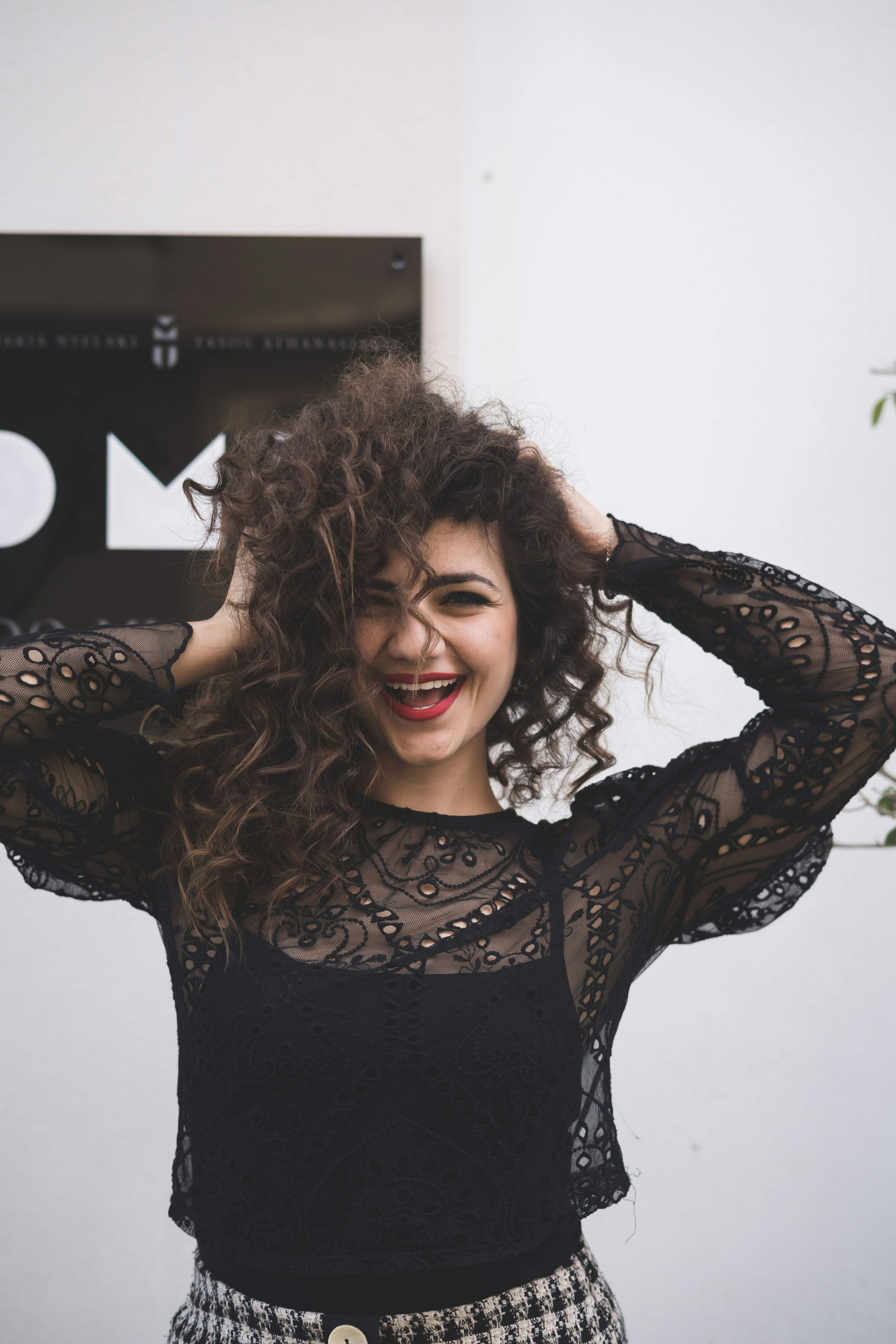 a woman with curly hair with a hush haircut