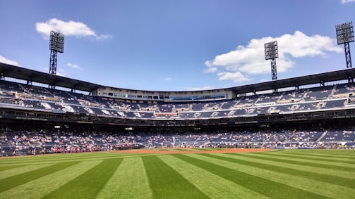 people watching football game during daytime