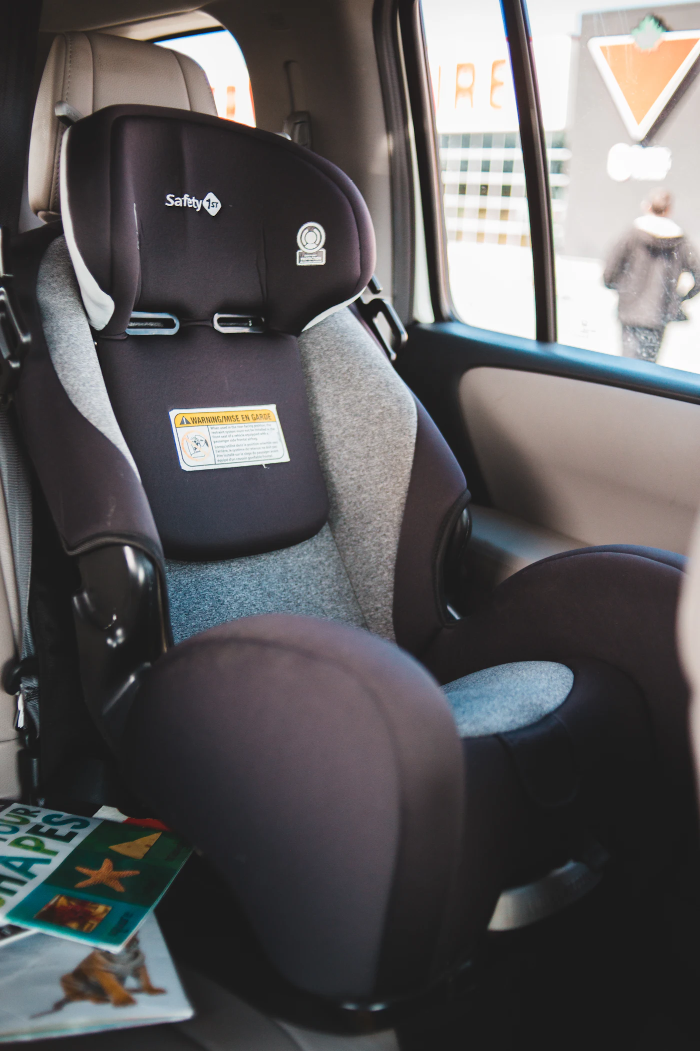 An empty child car seat installed in the back of a car