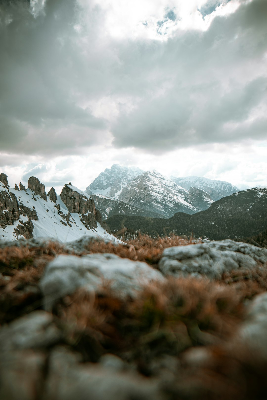 snow covered mountains under cloudy sky during daytime