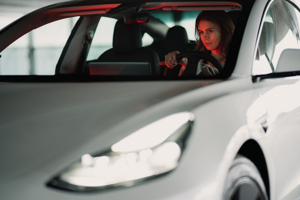 man in black jacket driving car