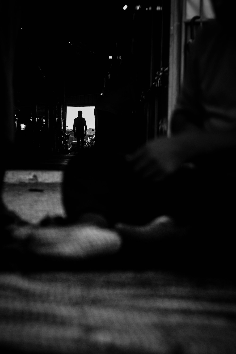 grayscale photo of person lying on floor