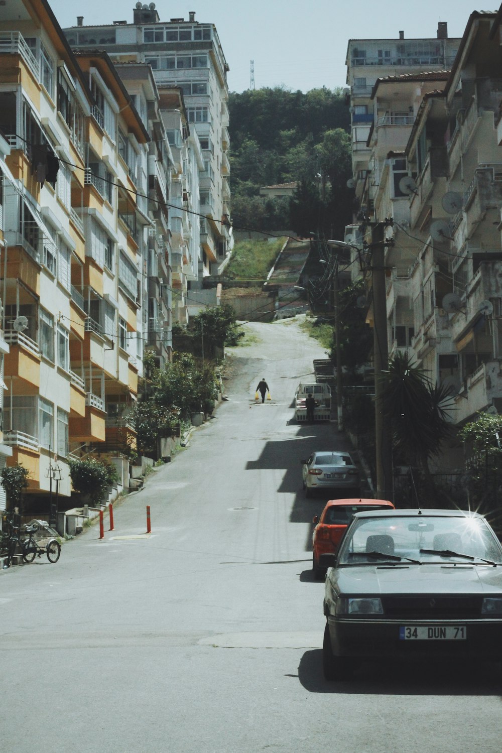 cars parked on side of the road in front of building during daytime