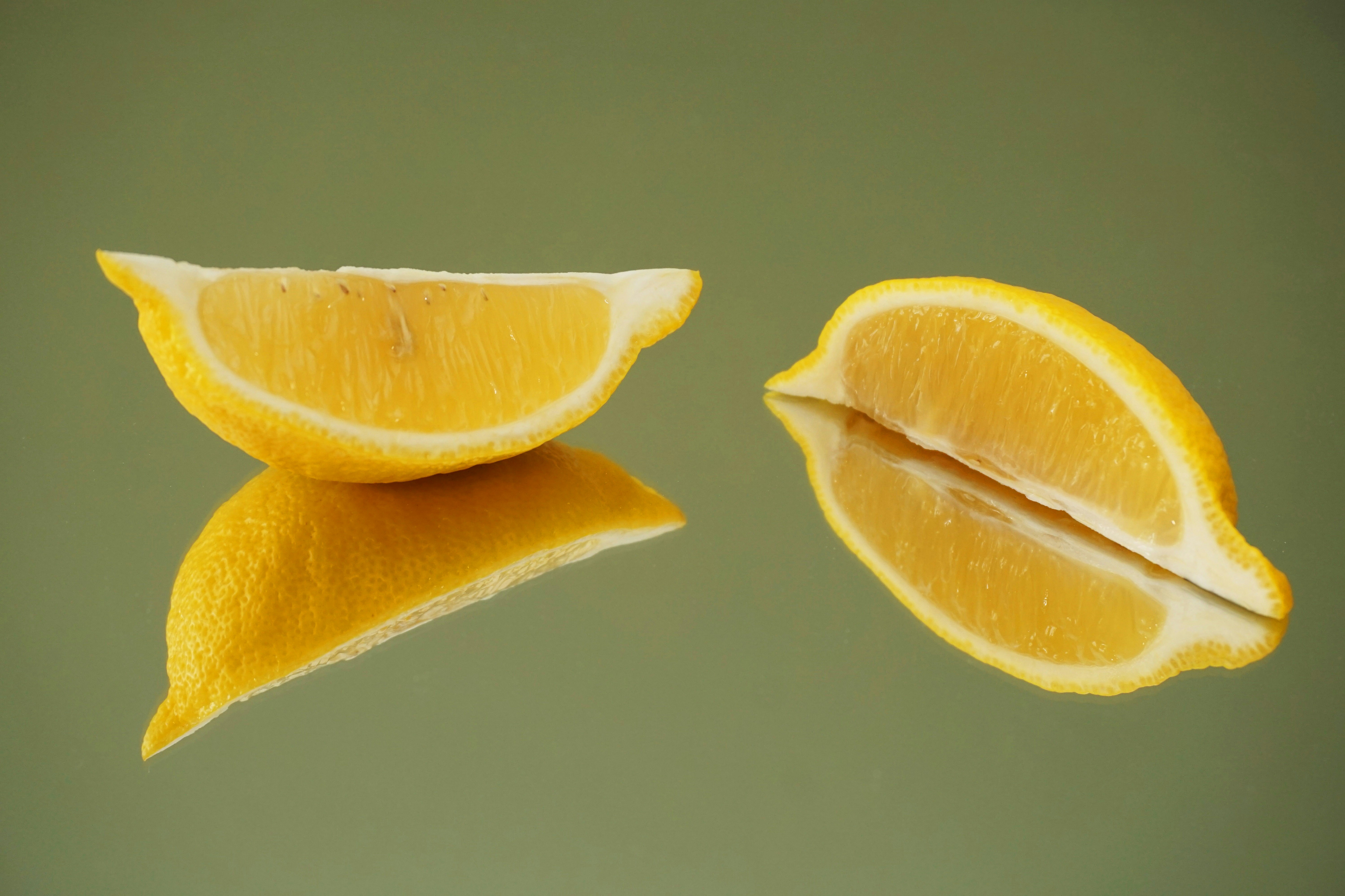 sliced lemon on white surface
