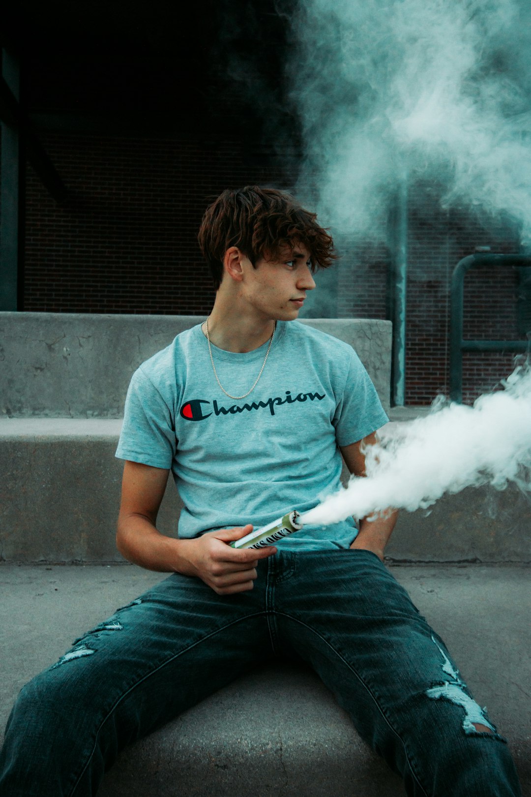 man in gray crew neck t-shirt smoking