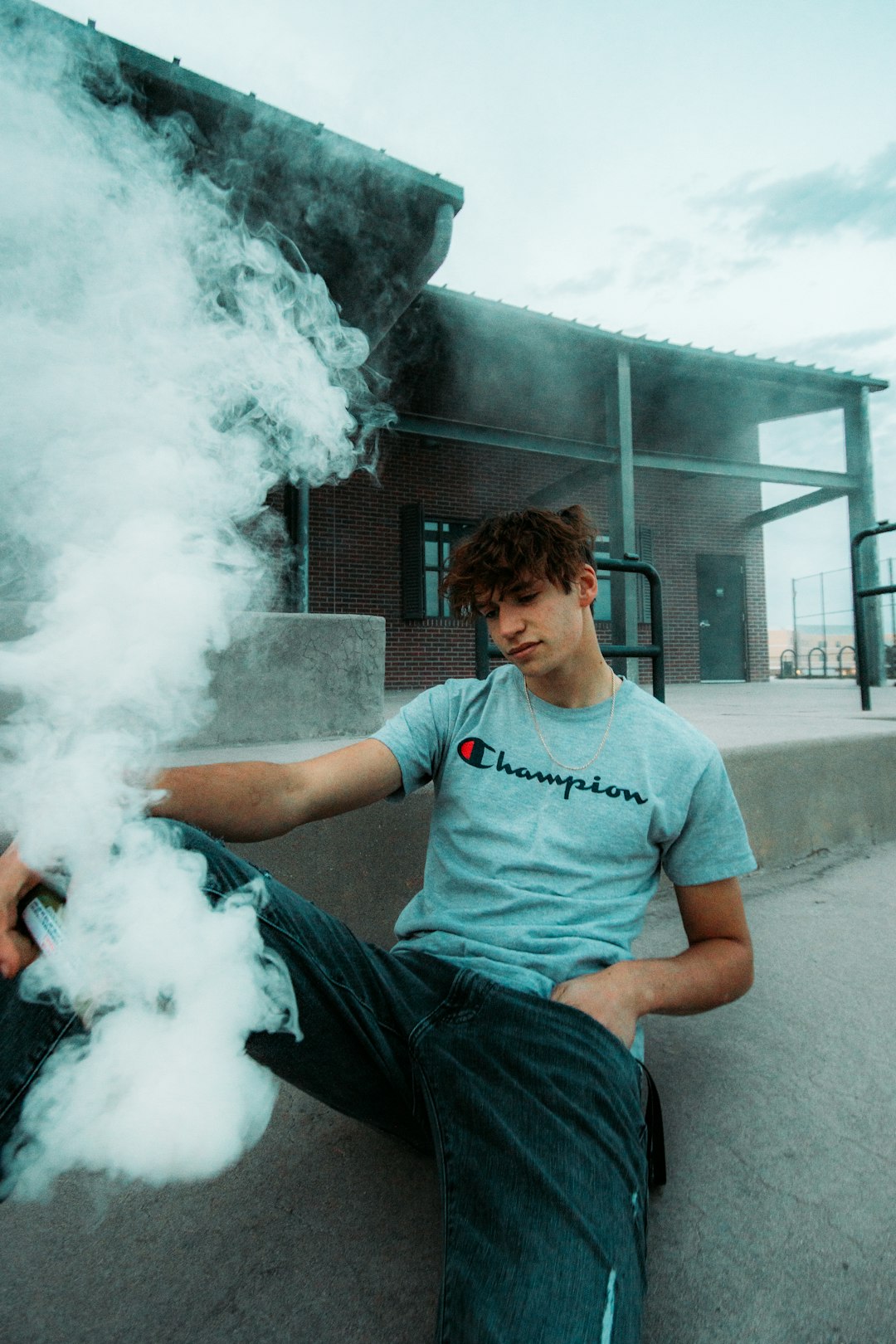 man in blue crew neck t-shirt smoking